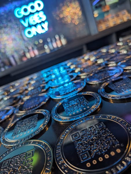 MOVE coins stacked on a counter with a Good Vibes Only sign in the background